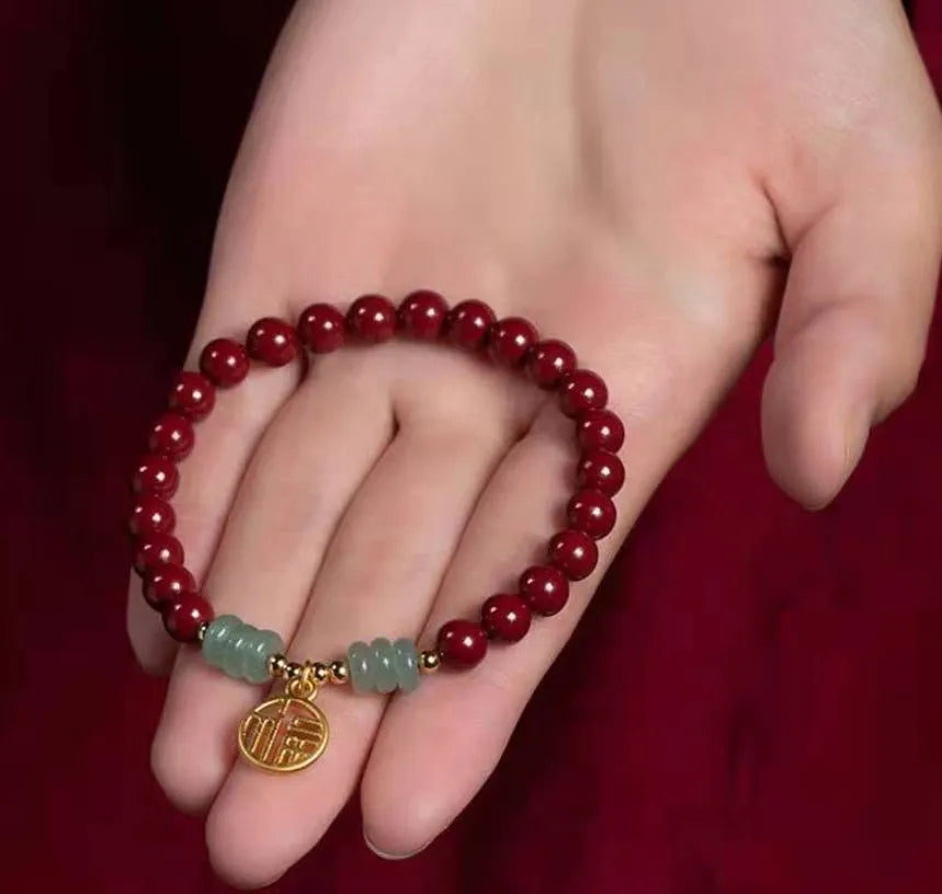 Handcrafted Chinese cinnabar bracelet with gold copper beads in wave design on wrist