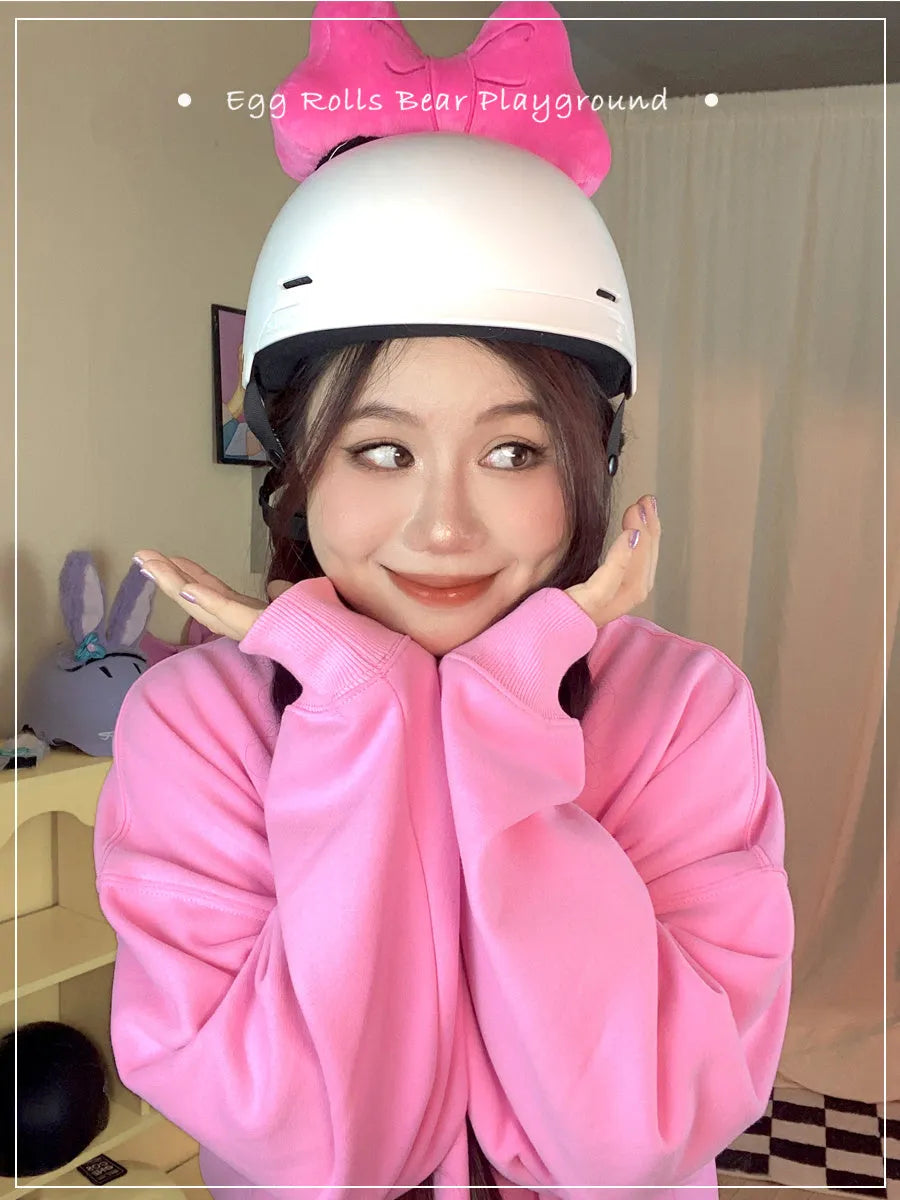 Soft plush bow helmet decoration for motorcycle and ski helmets in red or pink colours.