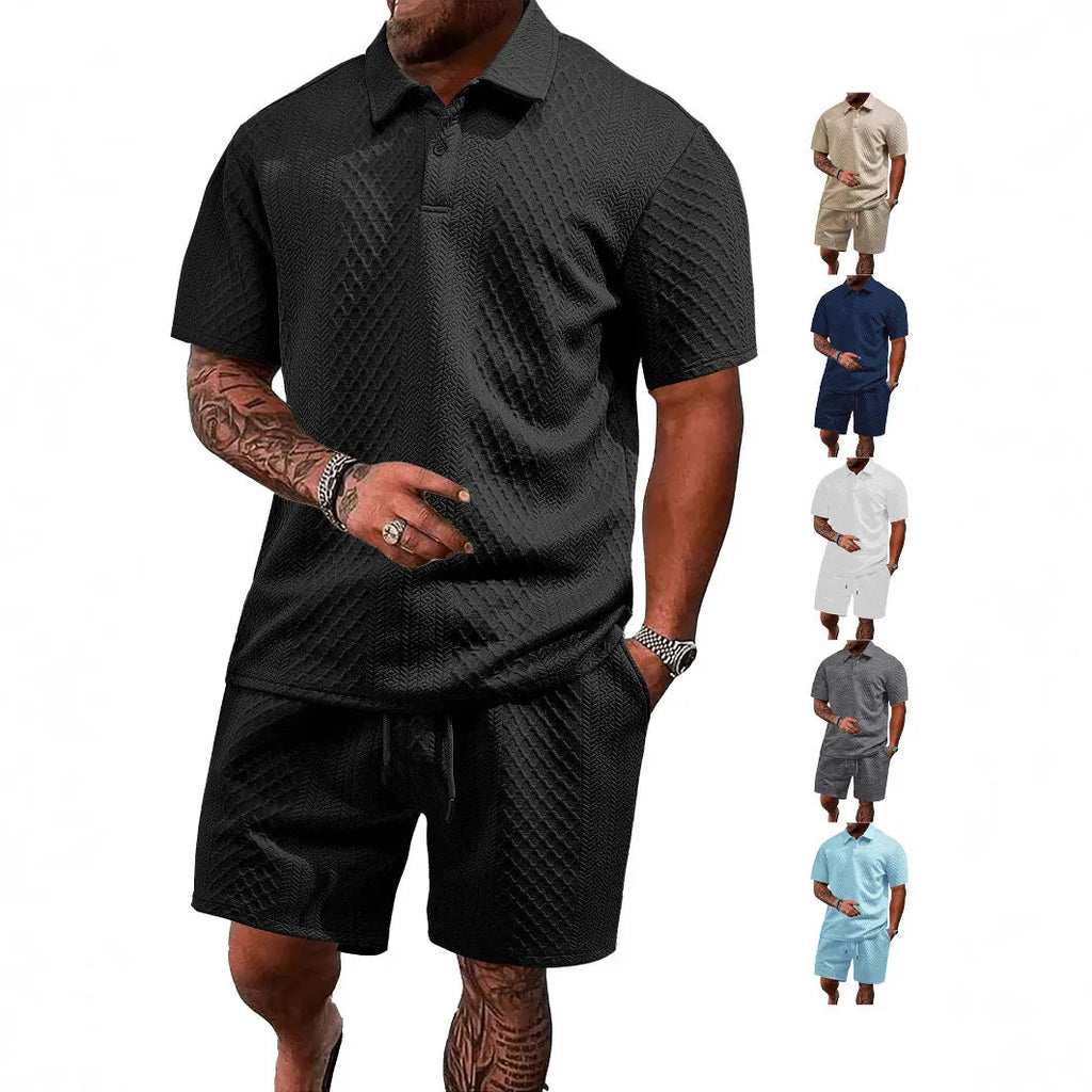 Man wearing a light grey thin figured cloth short-sleeve polo suit with matching trousers.