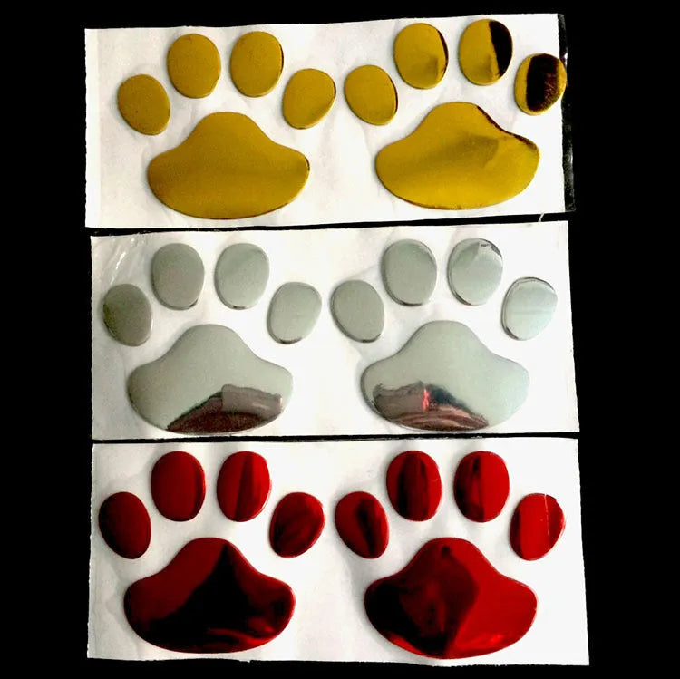 Pair of 7cm long PVC car stickers with a hand-shaped brush and dog footprints design in black, red, silver, and gold colour options.