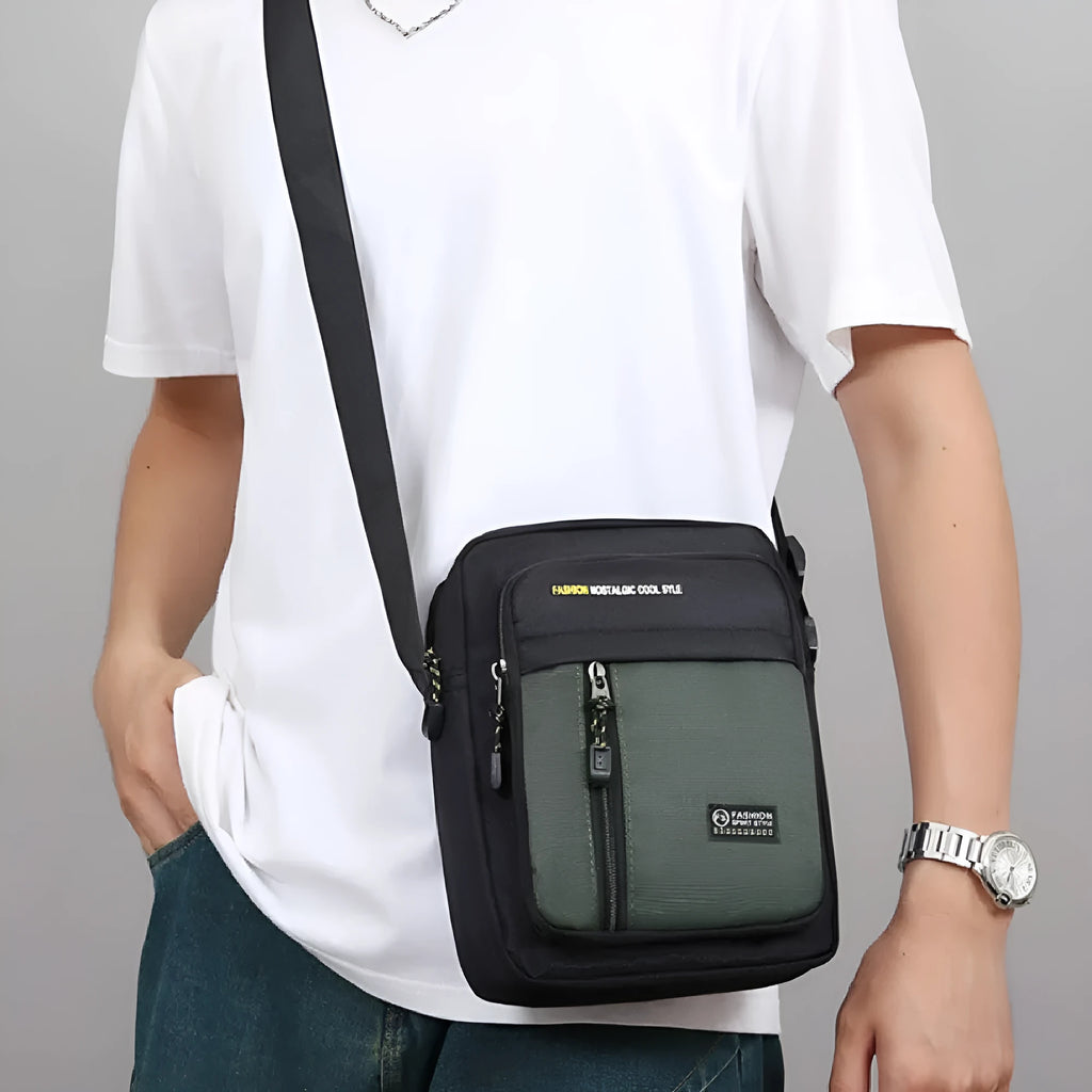 Men's casual nylon crossbody messenger bag in green, shown with visible stitching detail.
