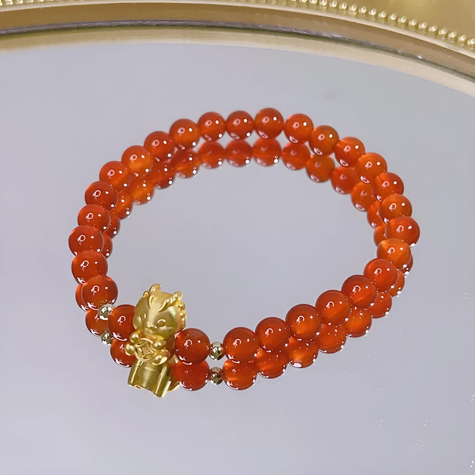 Handcrafted red agate bracelet with Chinese Dragon and Lucky Bag festival motifs