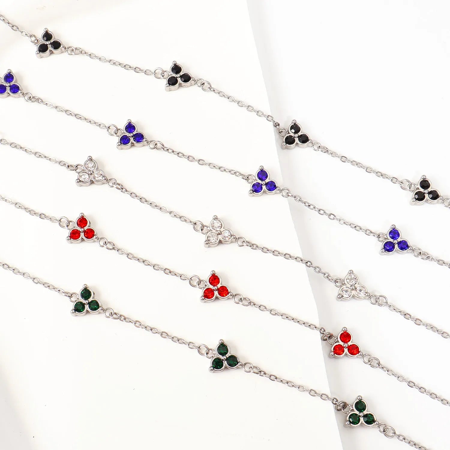 Geometric triangular stainless steel women's bracelet with coloured zircon stones in gold or steel finish.