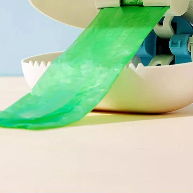 Blue cloud shape jaw dog pooper scooper on a lawn