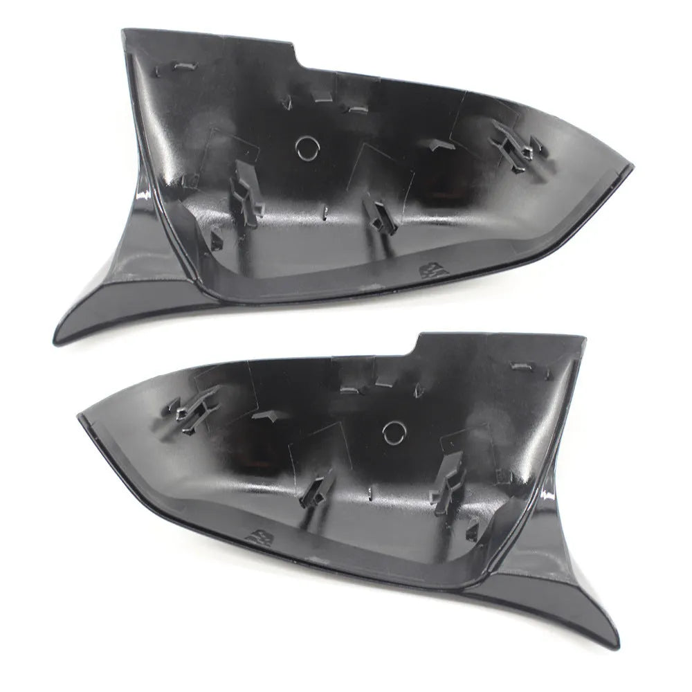 Pair of dark bright black BMW horn-style rear-view mirror replacement shells.