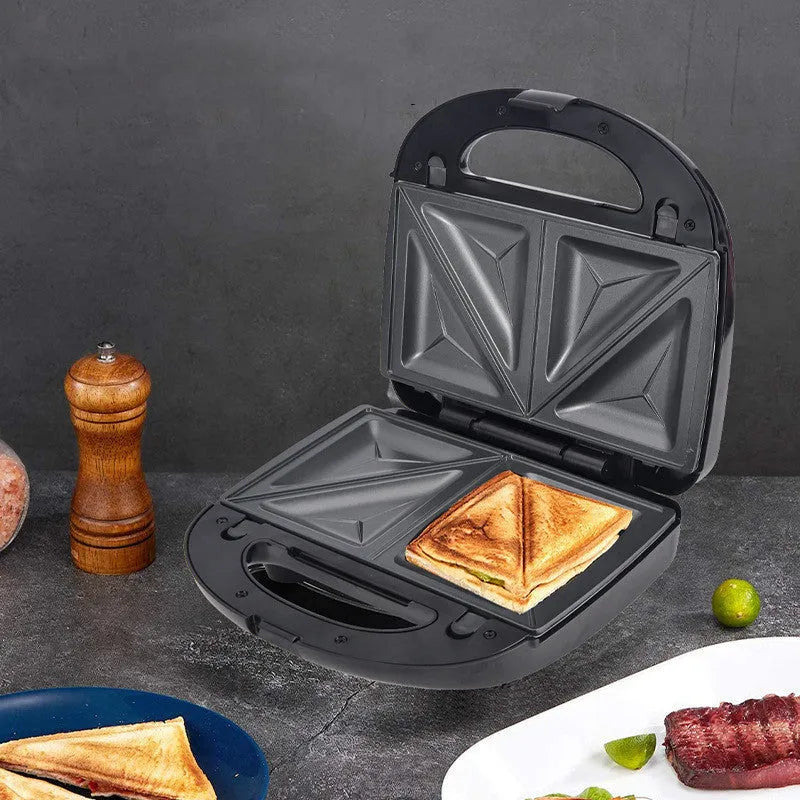 Black electric sandwich pan with stainless steel cover and non-stick baking surface