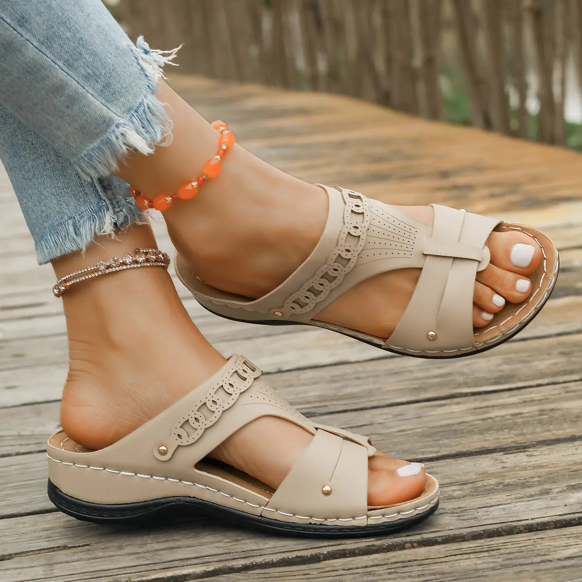Slope heel roman style slippers with fish mouth toe holder in various colours on a rubber sole.