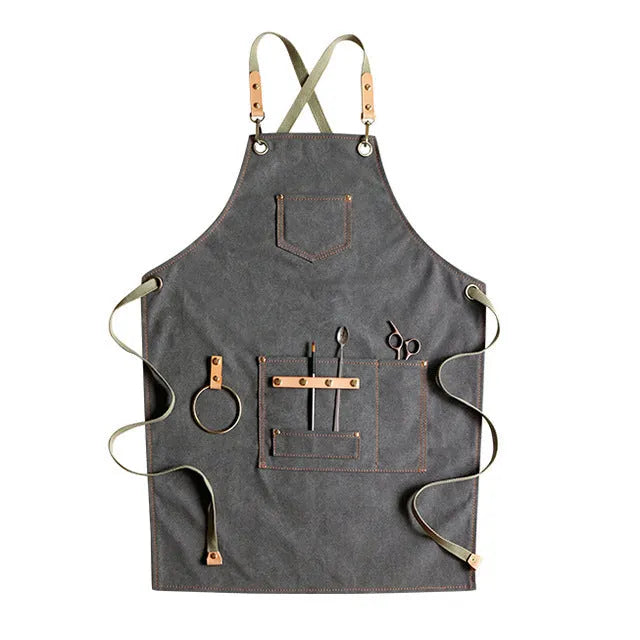Canvas apron with cross-back straps in camel colour, shown laid flat