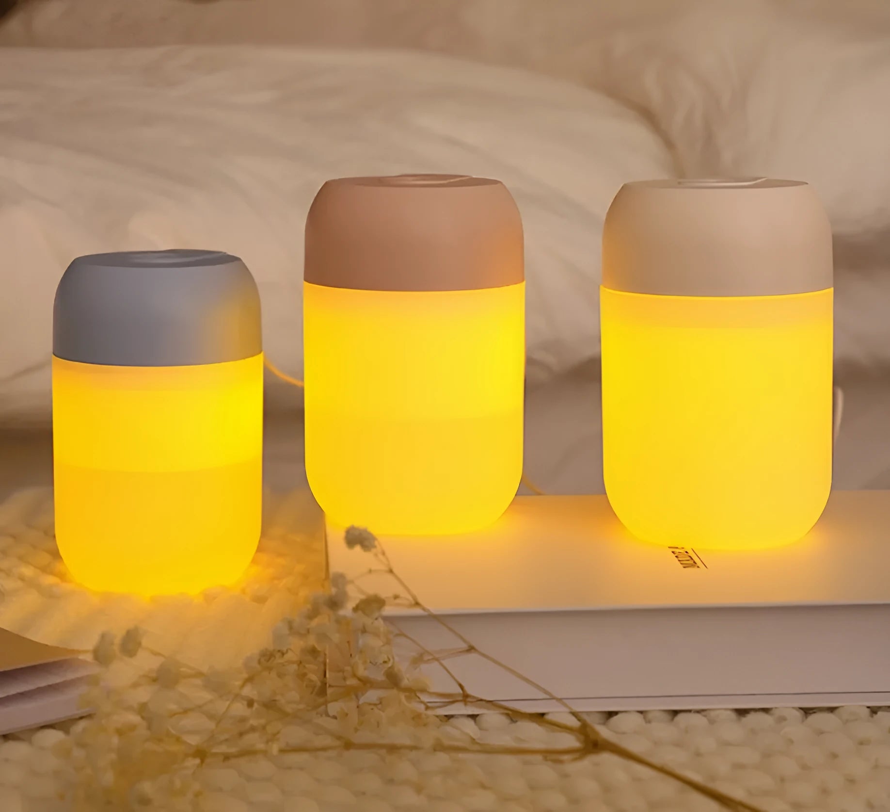 White cylindrical USB-powered small humidifier with aromatherapy function on wooden desk