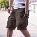 Man wearing loose-fitting army green cotton-blend retro workwear shorts for summer.
