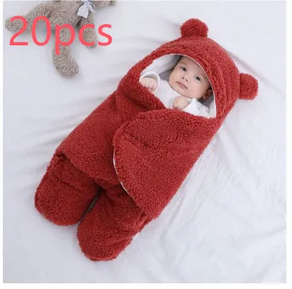 Baby quilted sleeping bag wrapper in cotton blend fabric, shown in grey colour with size tag.