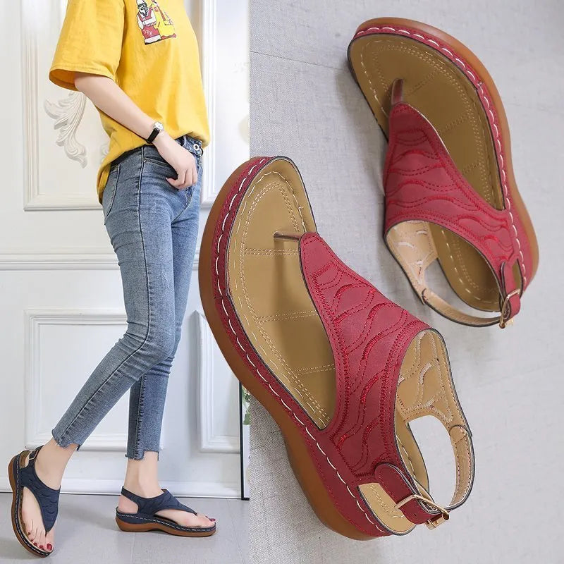 Women's casual wedge heel flip flop sandals with adjustable back strap in red vegan leather