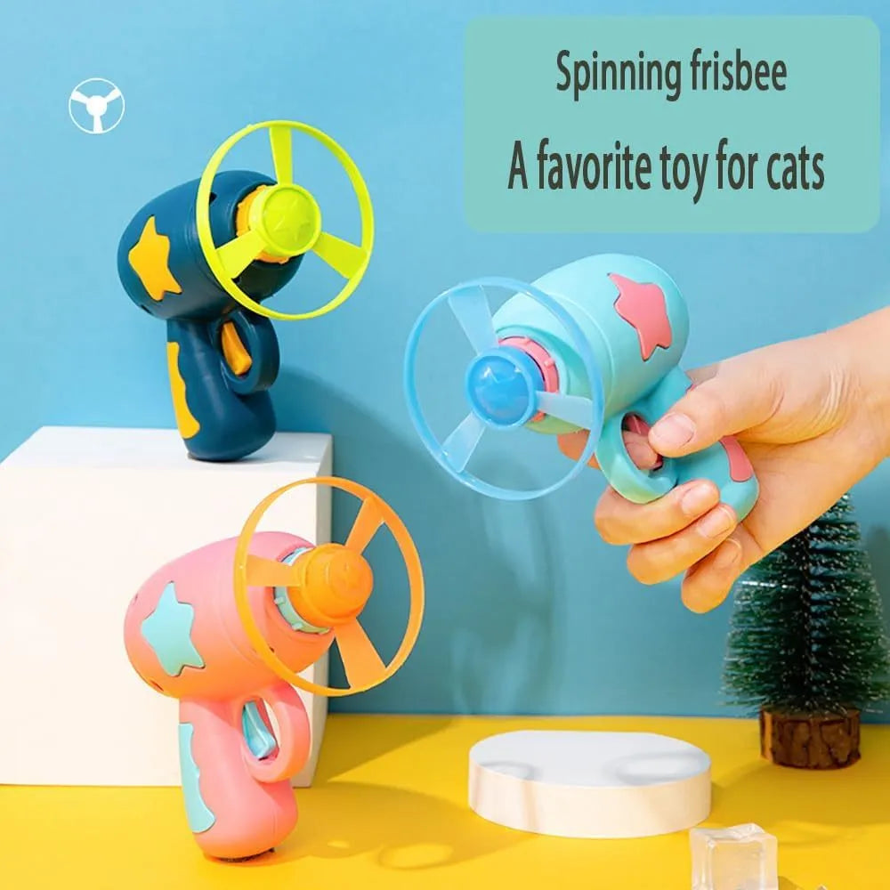 Blue or pink plastic cat toy gun launcher with spinning Frisbee for indoor cat play.