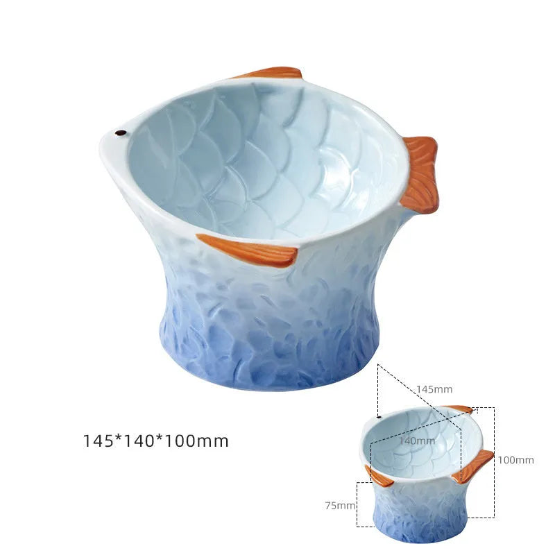 Set of four coloured fish-shaped ceramic cat bowls with a tilted, elevated design on a table.