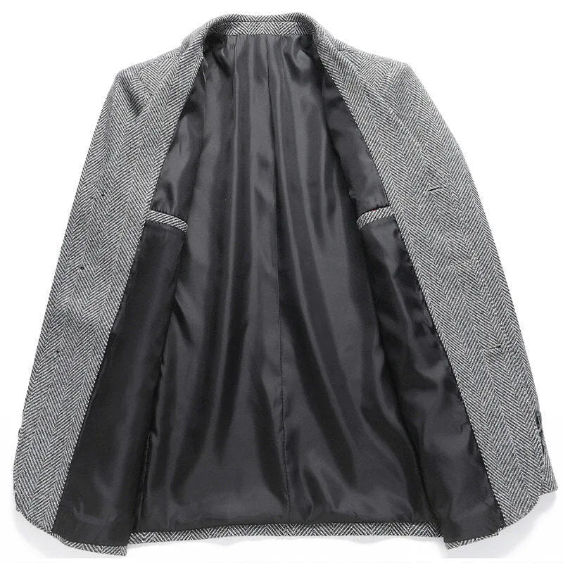 A man wearing a solid colour loose-fit wool blend coat suitable for spring or autumn.