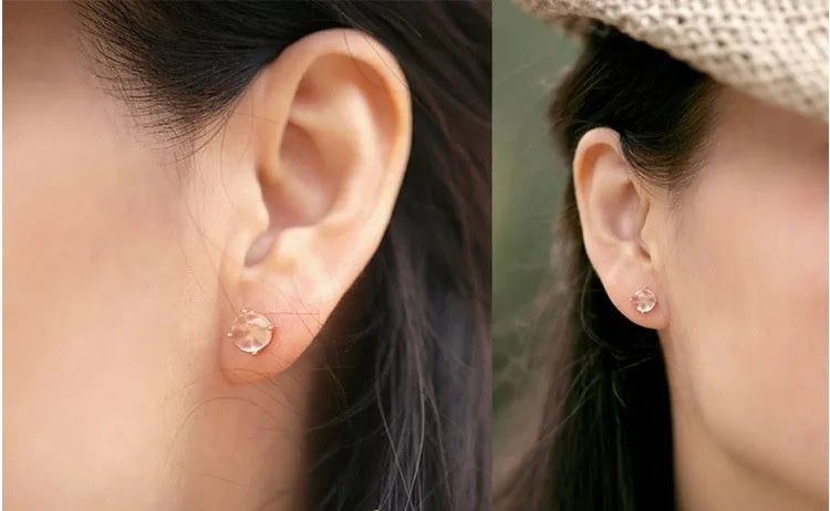 Rose gold drop-shaped stud earrings with crystal inlay detail.