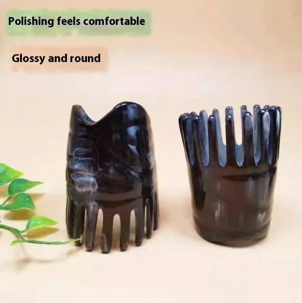 Black and white buffalo horn comb with wide teeth and a pointed end for hair massage and detangling.