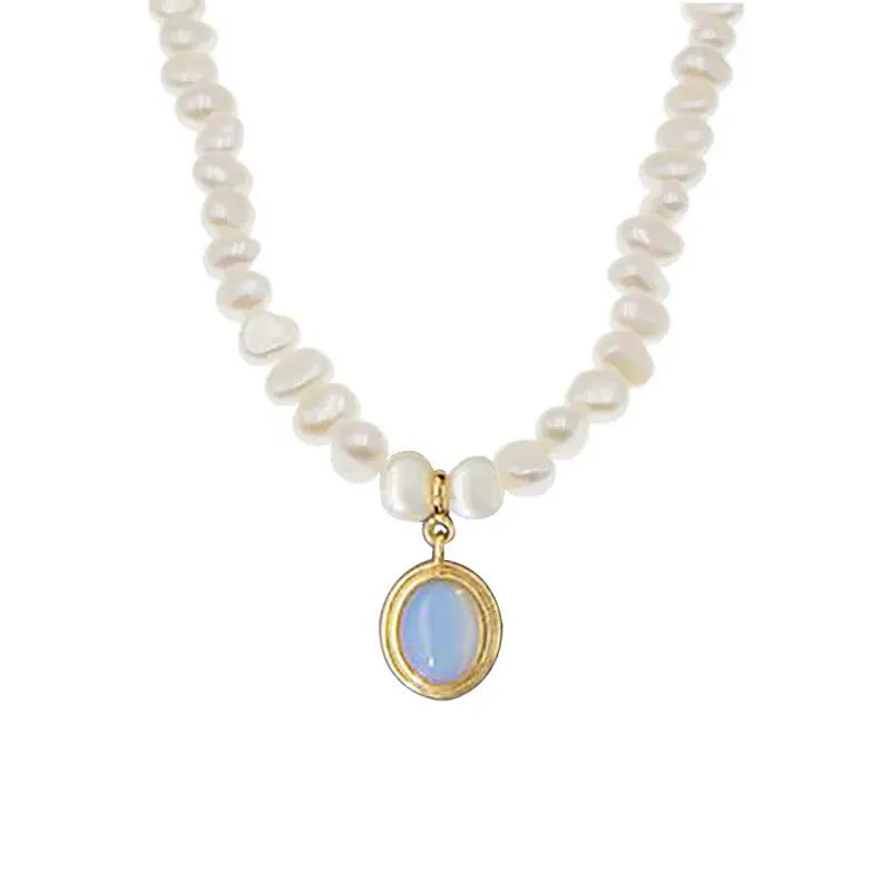 Sterling silver geometric necklace with irregular pearl pendant on adjustable chain.