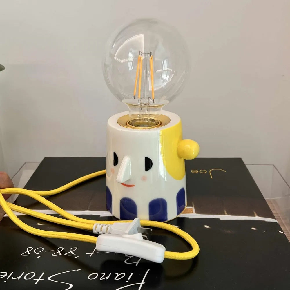 Handmade ceramic bedside lamp with ball headlight colour on wooden table