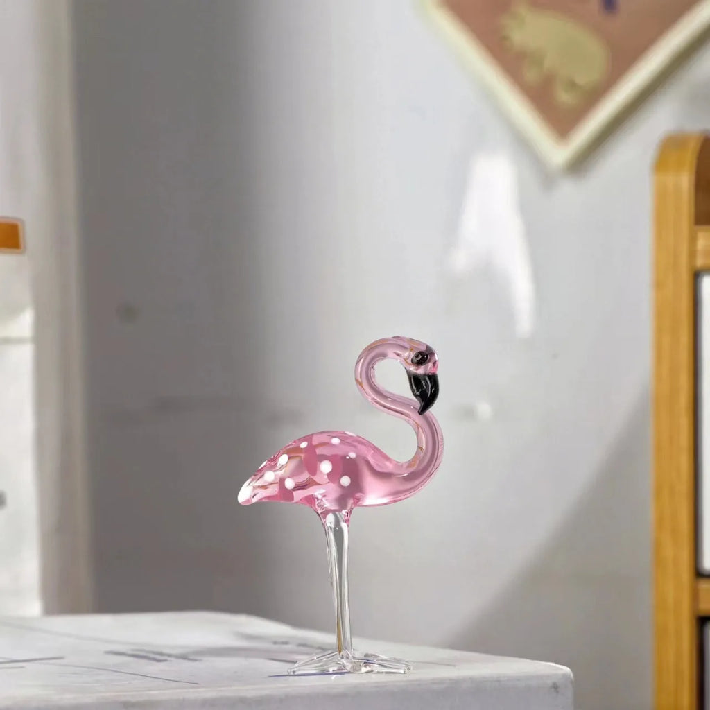 White crystal flamingo decorative ornaments with pink dots on a table