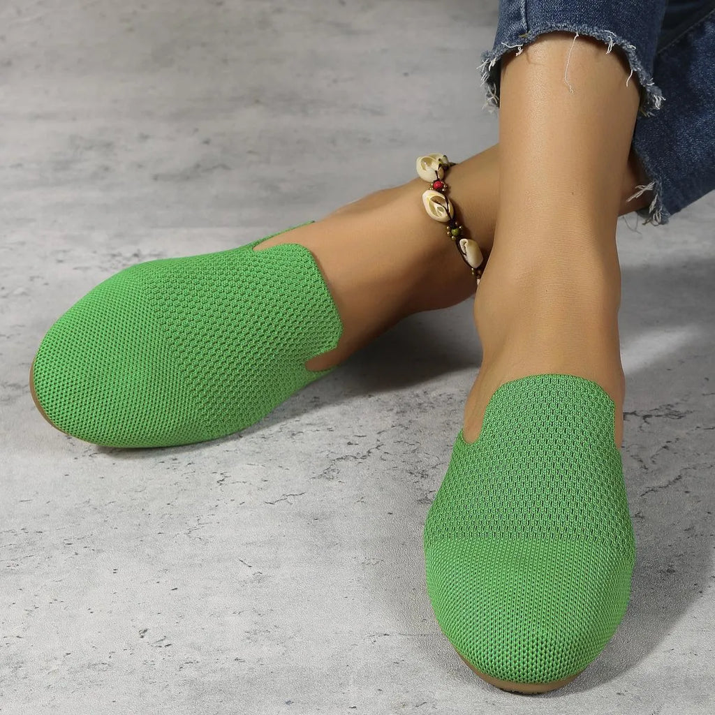 Pair of apricot-coloured mesh slip-on sandals with round toes and a flat rubber sole.