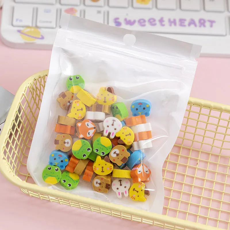 Assortment of fifty small cartoon-shaped rubber erasers in fruit and animal designs.