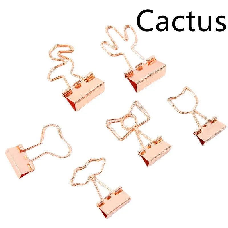 Gold-plated long tail hair clip showing decorative motifs including flamingo, love, clouds, cat, cactus, and bow designs