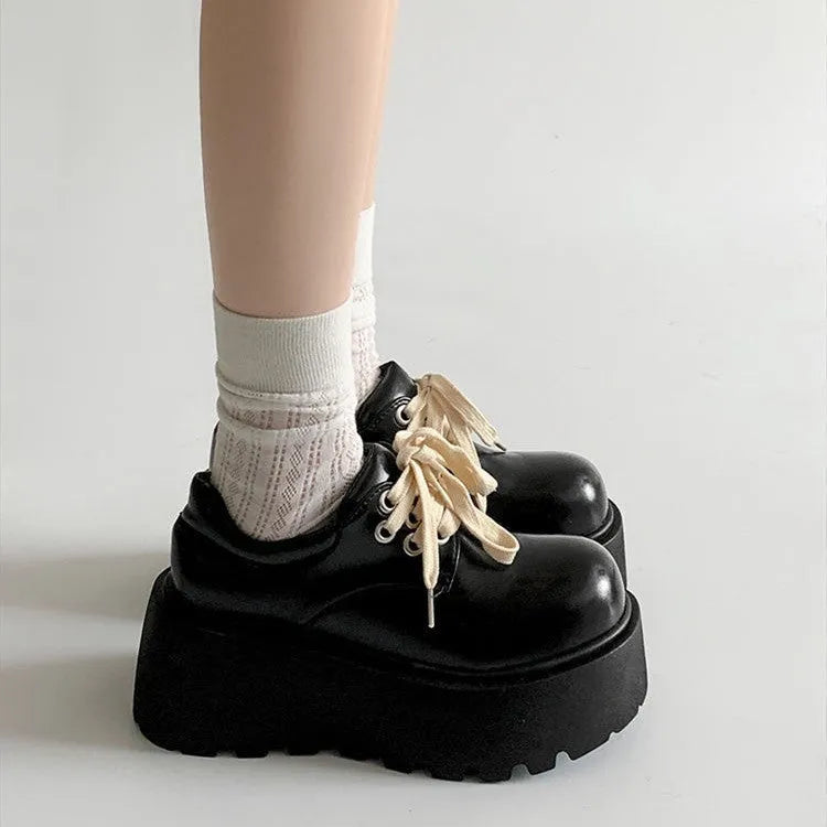 Women's matte black retro chunky sole lace-up ankle boots with a round toe on a white background.