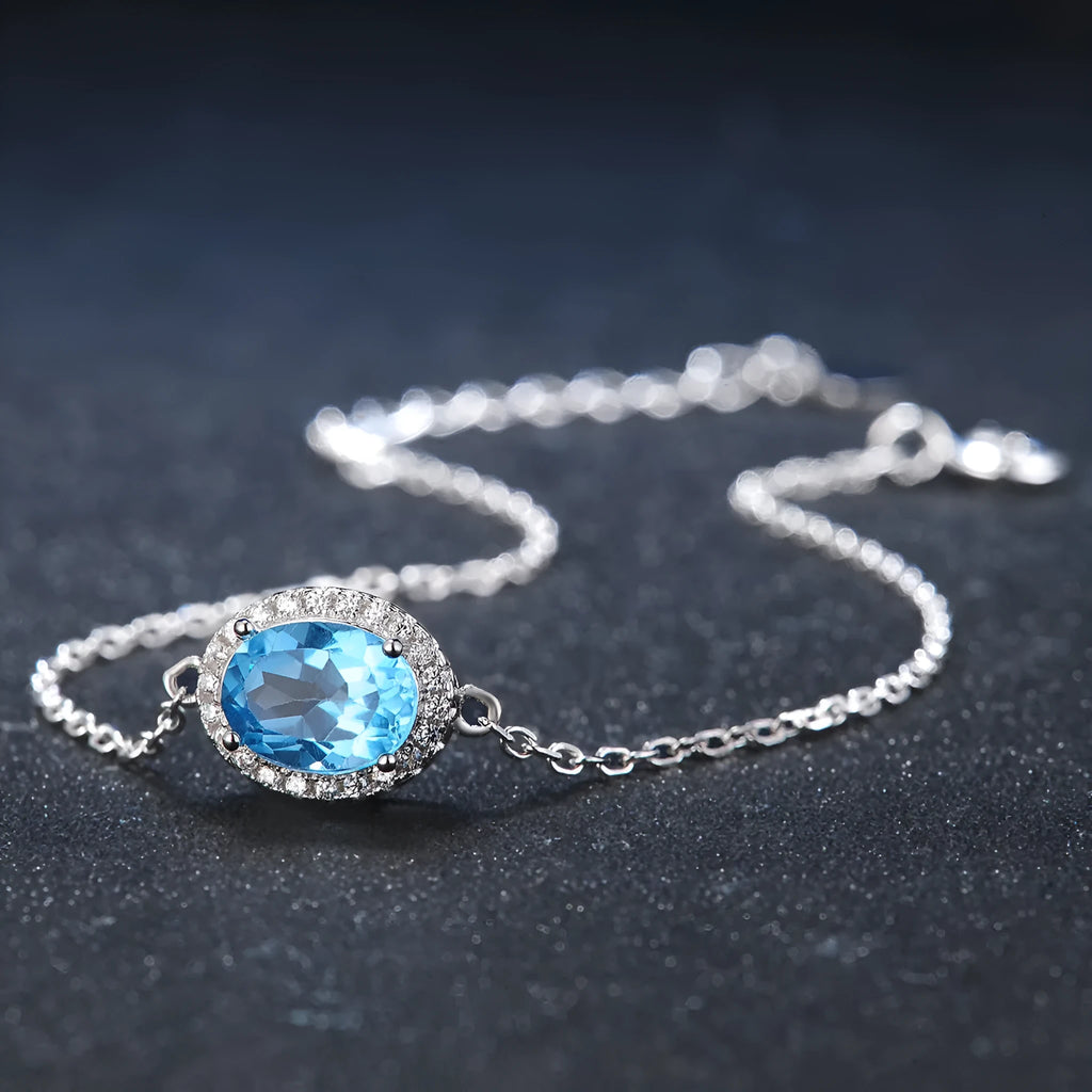 925 sterling silver jewellery set with blue topaz gems showing geometric patterned necklace, earrings, ring and pendant