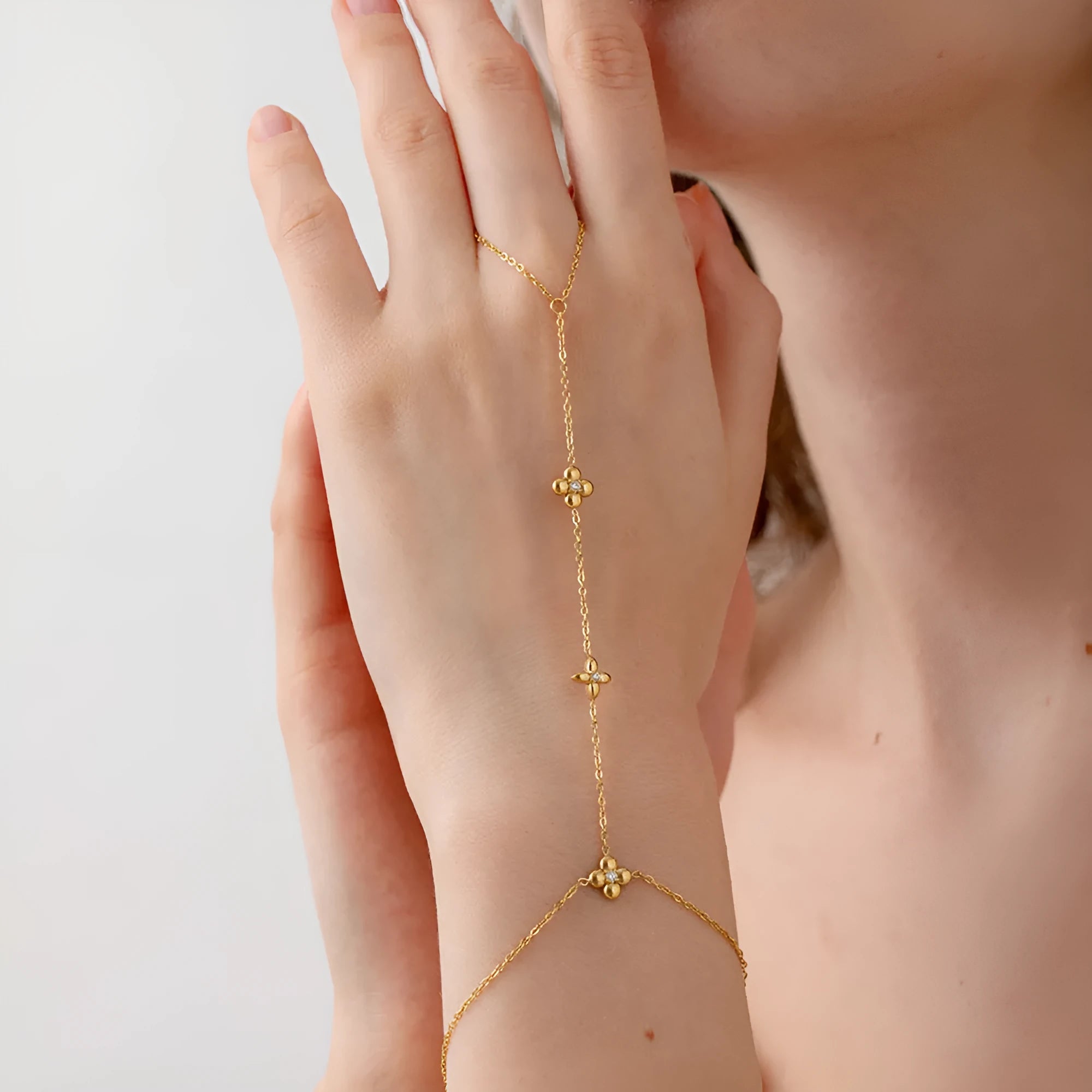 Gold stainless steel women's bracelet with geometric design showing floral patterns and eight-pointed star charms