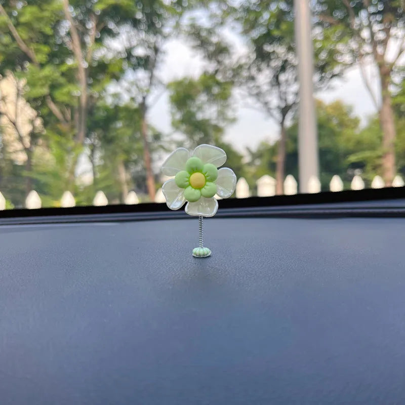 Blue plastic swing-shaped car decoration with a smiling face, hanging from a loop.