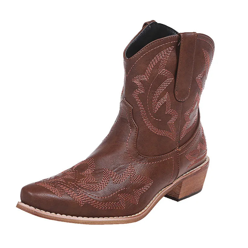 Women's blue embroidered cowboy boots with wedge heel and pointed toe on a white background.