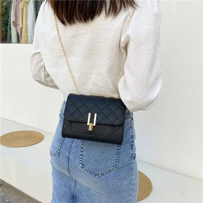 Women's white PU crossbody bag with diamond lattice texture and adjustable chain shoulder strap