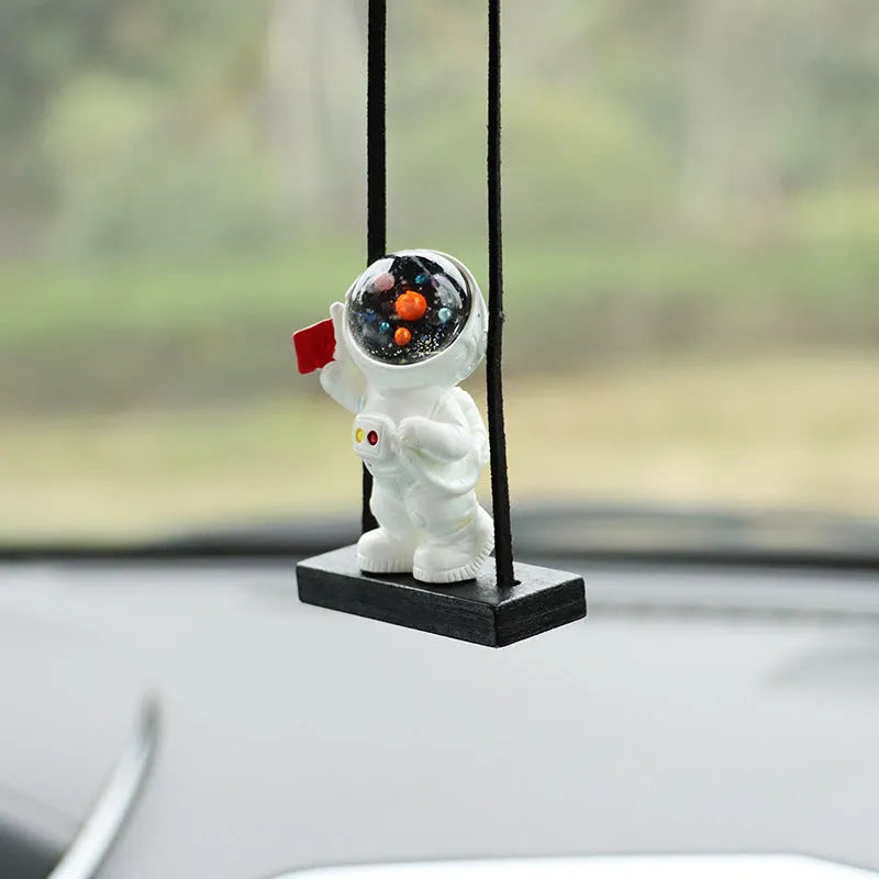 Cartoon astronaut resin pendant for car decoration, shown in various colour and style options.