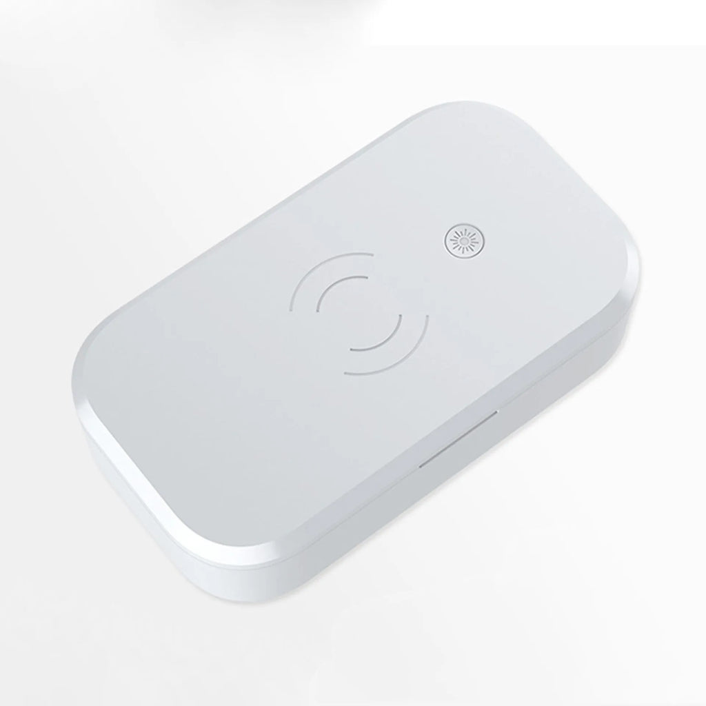 Compact white ultraviolet disinfection box with wireless phone charging pad on top.