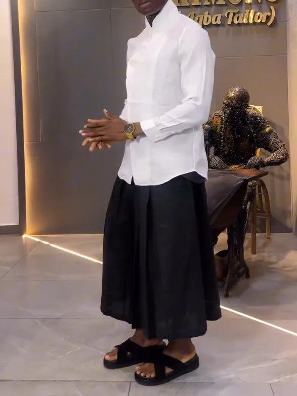 White asymmetrical front long sleeve shirt paired with black pleated trousers in a women's two-piece set.