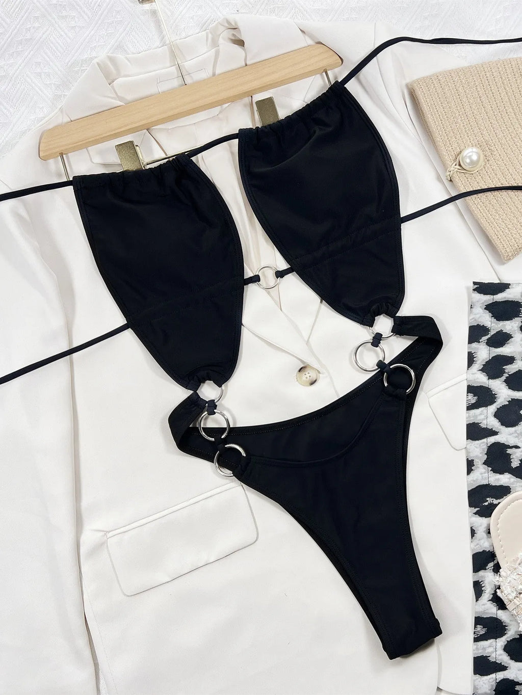 Black women's sleeveless one-piece swimsuit on hanger
