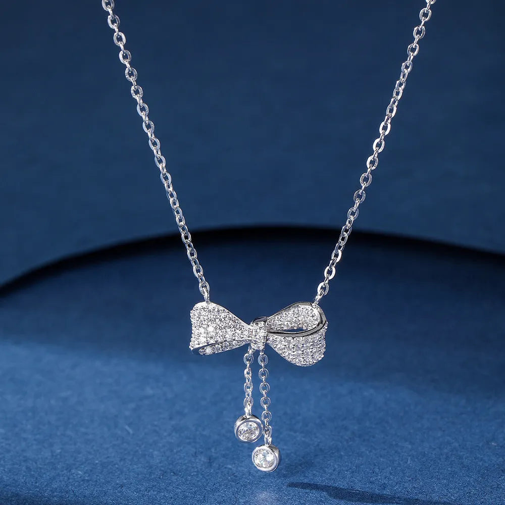 Silver bow pendant necklace on adjustable 40-45cm chain with O-ring closure