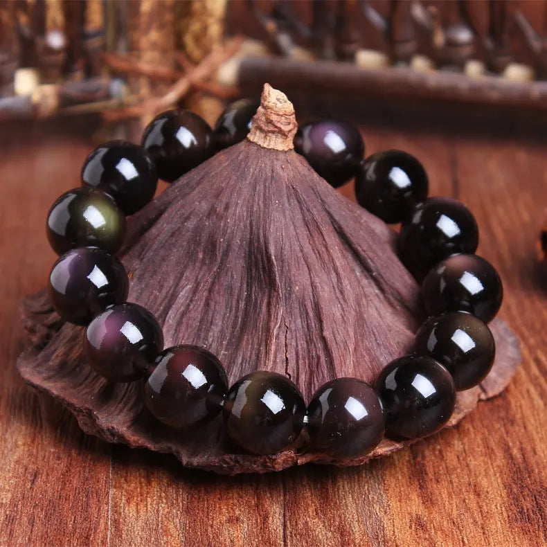 Polished icy obsidian crystal Pi Xiu bracelet with geometric ethnic style on adjustable cord.