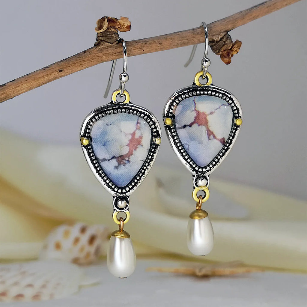 Retro blue Bohemian style drop earrings with geometric metal design, synthetic blue opal and white pearl elements