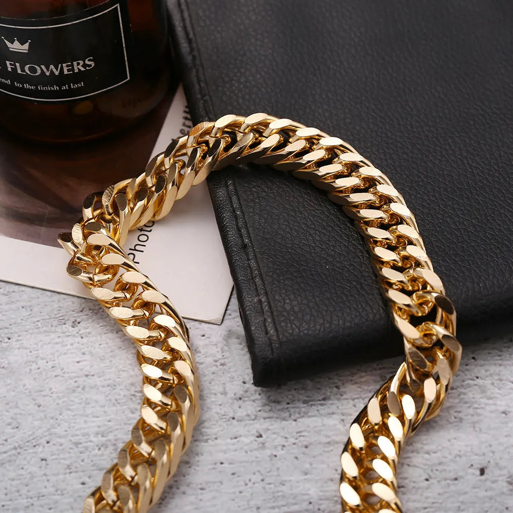 Gold coloured thick chain necklace for women on a white background.