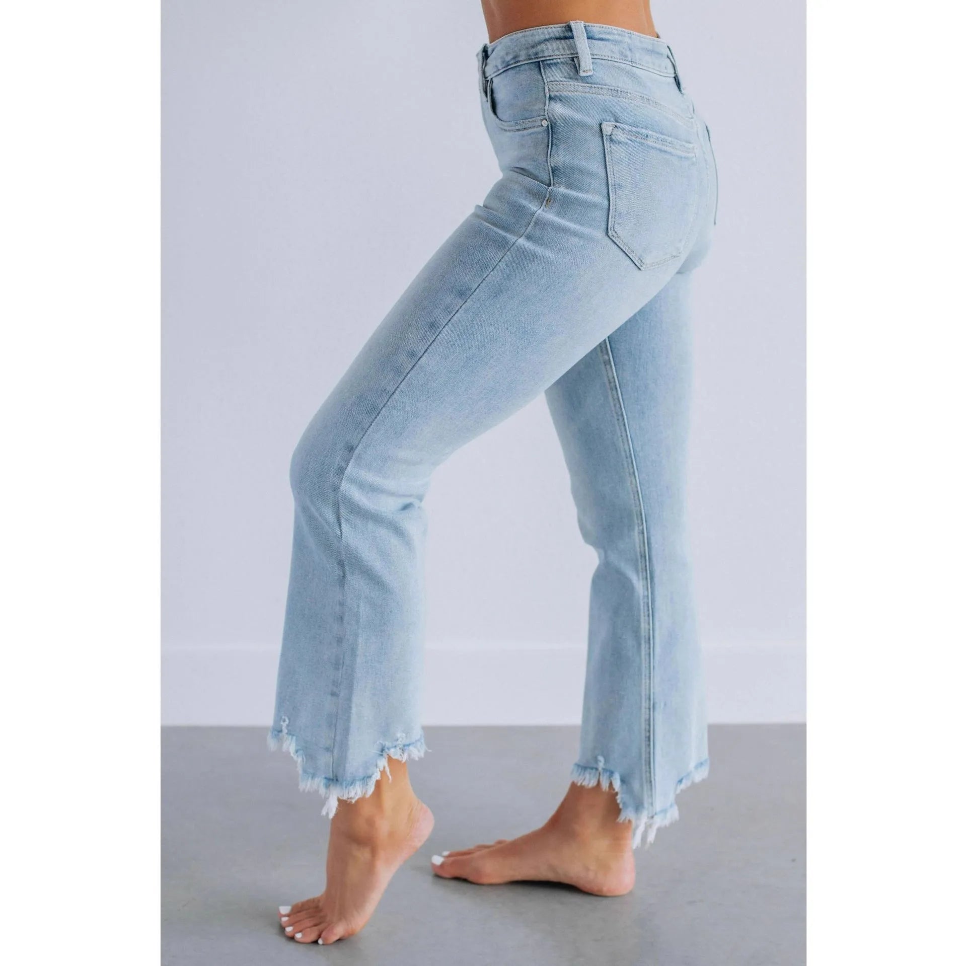 Women's solid blue denim trousers with a casual, hand-worn finish on a hanger.