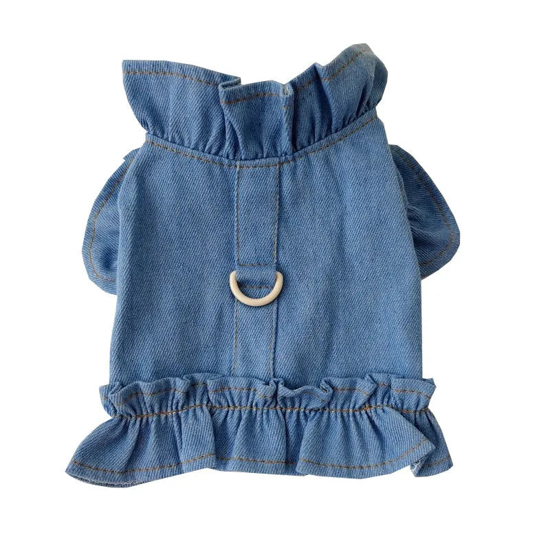 Blue denim dog dress with a ruffled vest design and a metal leash hook on the chest.