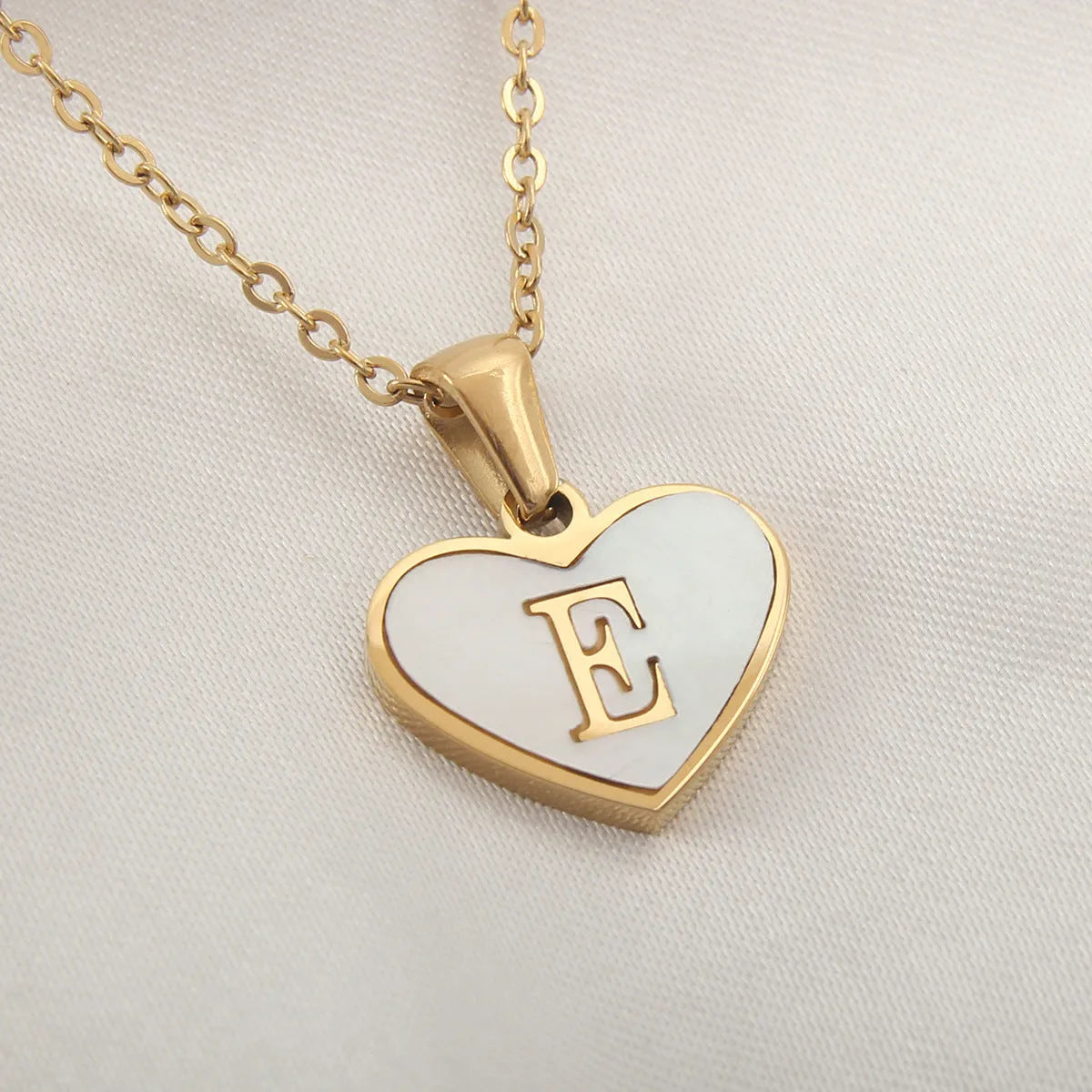 Gold heart necklace with white shell pendant and initial charm on 45cm adjustable chain