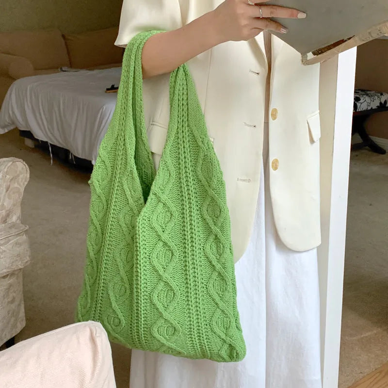 Women's crochet knitted shoulder tote bag in a solid colour with hollow retro design and double straps.