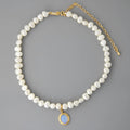 Sterling silver geometric necklace with irregular pearl pendant on adjustable chain.