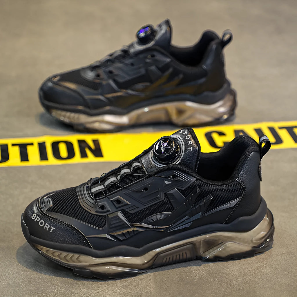 Men's black casual shoes with rotating button fastener and mesh upper on a rubber platform sole.