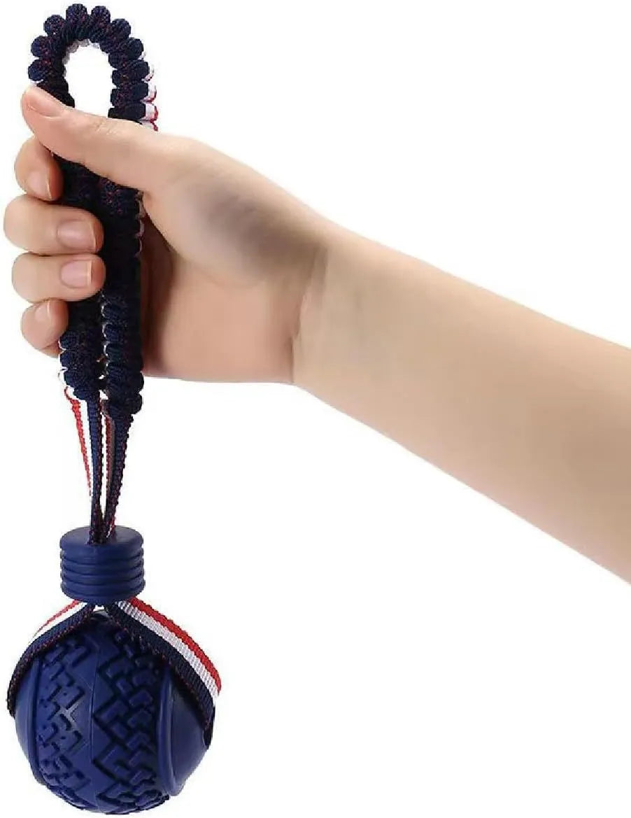 Blue or red natural rubber dog ball on rope toy measuring 29cm total length with 6.5cm diameter ball