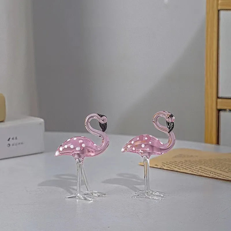 White crystal flamingo decorative ornaments with pink dots on a table