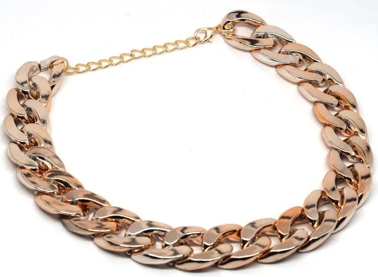Geometric twisted chain dog collar with buckle on a white background, shown in a gold colour.
